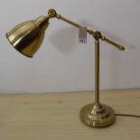 A modern adjustable desk lamp in 19th century anglepoise style with adjustable shade and height etc.