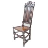 A heavy and darkly patinated early 18th century oak side chair; the carved pierced scrolling top