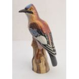 A late 19th / early 20th century German porcelain shaped model of a blue jay perched upon a tree
