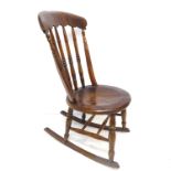 A late 19th century lathe-back elm and beech rocking chair; the large shaped and figured elm top