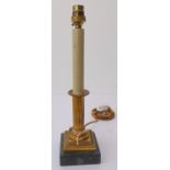 A single ormolu table lamp of classical column form upon a black square marble base (total height