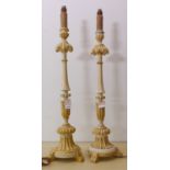 A pair of cream and gilt highlighted table lamps with faux candle tops (full height including