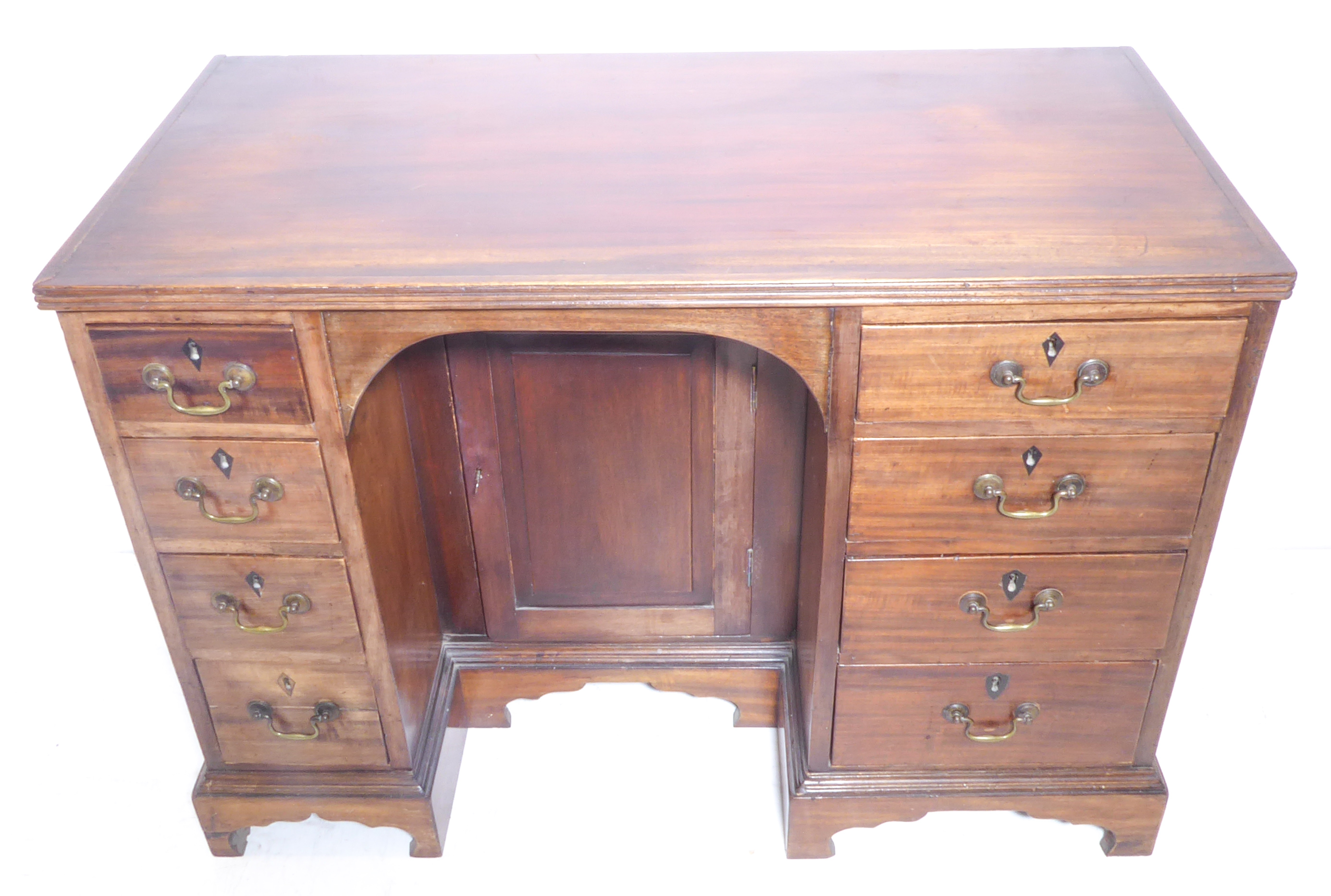 An early 19th century George III period mahogany knee-hole desk - the reeded edge top above recessed