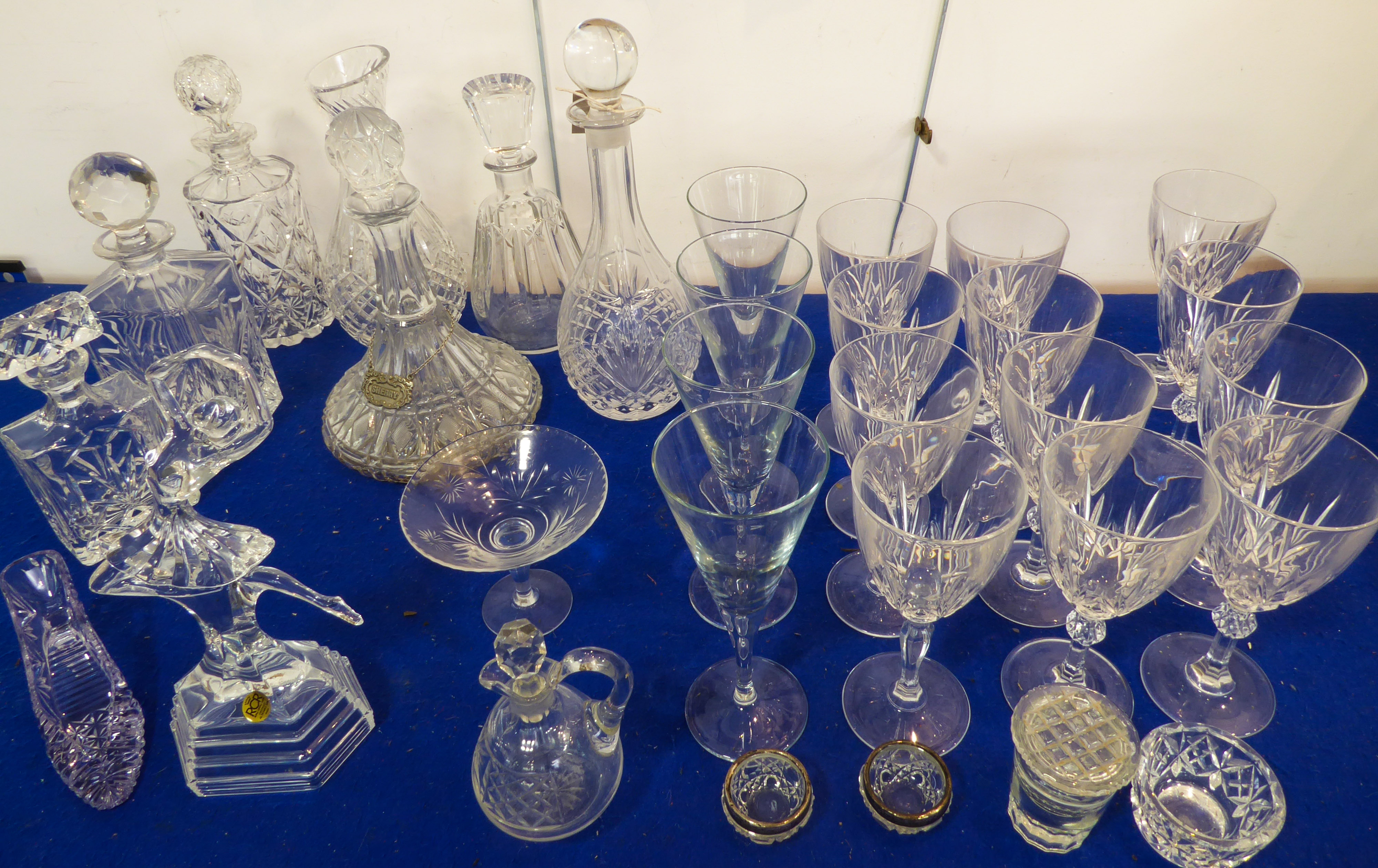 A selection of glassware to include 6 decanters, a set of 8 hand-cut wine glasses with circular