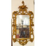 A Chippendale-style carved giltwood wall-hanging looking glass (mid-20th century) - the pierced