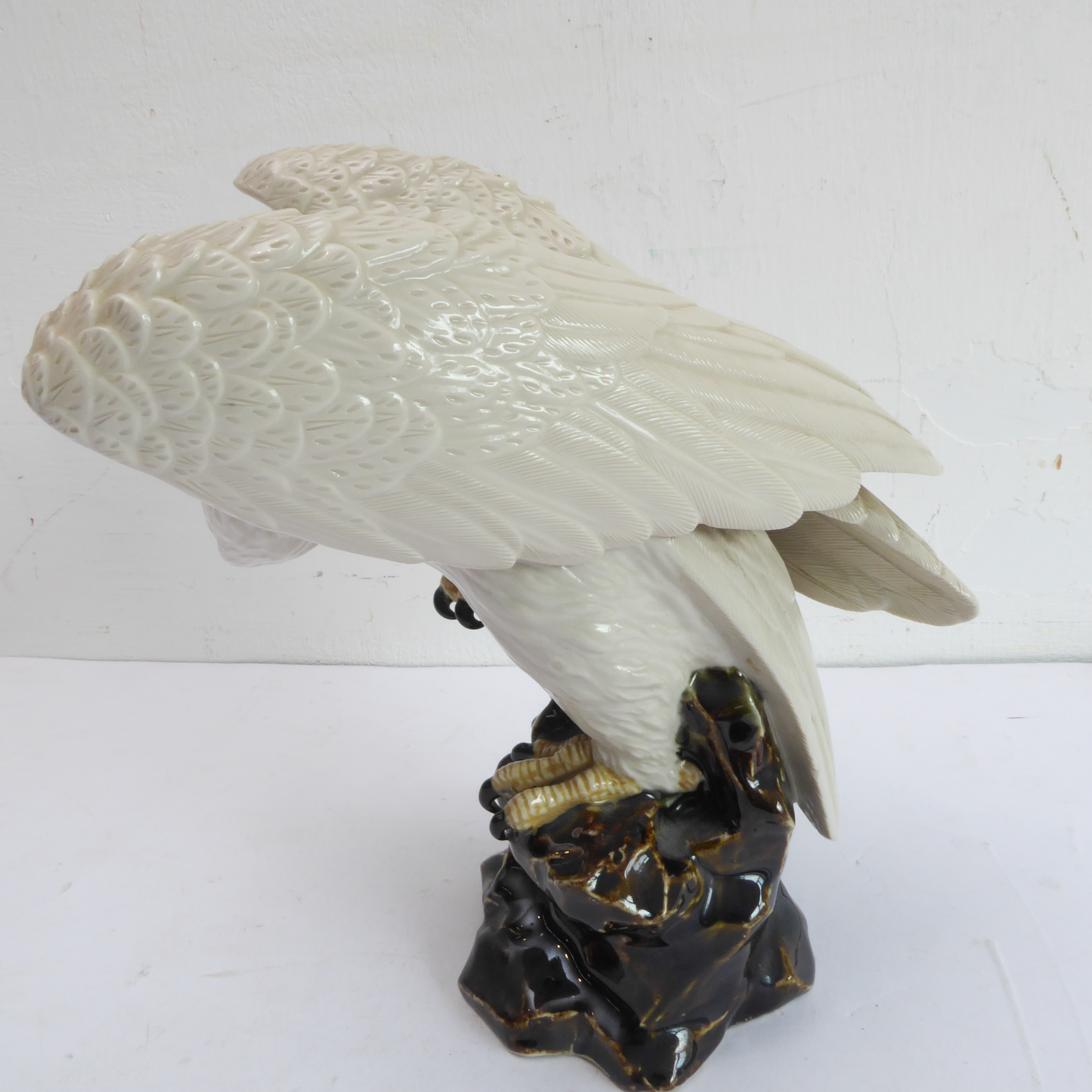 A 20th century hand-decorated porcelain model of a large white eagle perched upon rockwork (possibly - Image 2 of 4