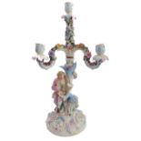A late 19th century hand-decorated German porcelain four-light figural candelabra. The central