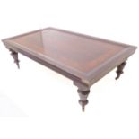 A hardwood flame-mahogany-banded coffee table in antique style - brass corner mounts, raised on