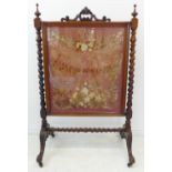 A mid 19th century rosewood fire screen of elaborate form and size; the pierced pediment with