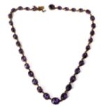 A 19th century amethyst collet necklace, each graduated oval amethyst within a yellow gold cut-