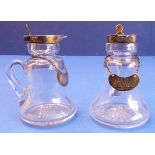 A good pair of bell-shaped whiskey tots with silver mounts and star-cut bases; the hinged lids