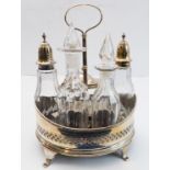 A hallmarked silver boat-shaped cruet - five divisions with glass bottles including two castors with