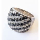 A silver ring mounted with diagonally set black and white stones (size O / P) (boxed)