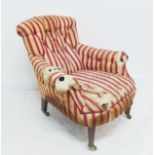 An Edwardian button-back upholstered armchair for restoration; the distressed original silk