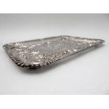 A hallmarked silver trinket tray - decorated in repoussé style in relief with five winged cherubic