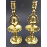 A pair of 19th century cast-brass candlesticks; the middle section with hinged bells (no