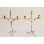 A pair of stylish Arts and Crafts style, height adjustable, two-light candelabra; large circular