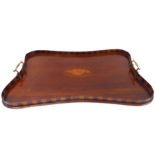 An Edwardian mahogany two-handled serving tray; concave galleried sides and two brass carrying