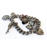 A silver charm bracelet - the seven charms to include a painted windmill; champagne on ice; a bust