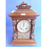 A late 19th century walnut gilt-metal-mounted eight-day mantle clock; the finely carved pediment