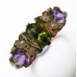 A 9-carat gold suffragette-style ring set with a peridot flanked by pearls and amethysts (ring