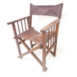 An early 20th century folding oak and brown leather Director's style chair; vertical turned