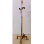 An unusual gilt metal adjustable-height double table lamp upon pronounced tripod base with elongated