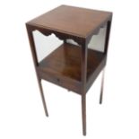 A George III mahogany side table; shaped aprons above single full width middle drawer and raised