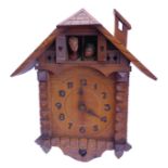 An usual Swiss / Black Forest cuckoo-style 'kissing' clock; the pendulum terminal modelled as a