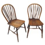 A pair of 19th century comb-back-style chairs; the elm seats of good colour and patination, turned