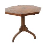 An early 20th century Arts and Crafts style octagonal topped occasional tilt top table; walnut