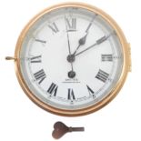 A mid-20th century brass-cased ship's wall-mounting clock - circa 1940s, white-enamel dial with
