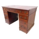 A 19th century mahogany pedestal desk: the gilt-tooled red Morocco leather inset top with