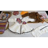 A good and interesting selection of hand-stitched wall hangings, clothing, two carry-bags and a rare