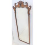 An early 18th century style (early 20th century) walnut wall hanging looking glass of slim