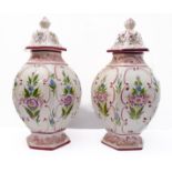 A pair of large and showy ceramic Portuguese vases and covers of hexagonal form, each hand-decorated