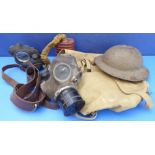 A British Army canvas haversack containing two gas masks, Brodie helmet and Sam Browne leather belt