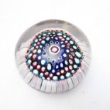 A heavy 19th century circular glass paperweight with millefiori-style canes (4cm bruise)