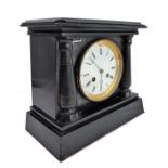 A 19th century slate mantle clock, the white enamel dial with Roman numerals, flanked by two