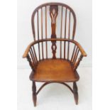 A mid-19th century Windsor chair; ash bow, pierced splat above an elm seat and turned legs united by