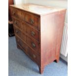 An early 19th century mahogany chest; four full-width graduated drawers with stamped brass ovals,