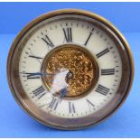 A 19th century bedside-style clock; brassed case, cream enamel dial with Roman numerals and ornately