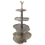 A heavy and unusual cast-iron etagere modelled as a vertical branch with four shaped concentric