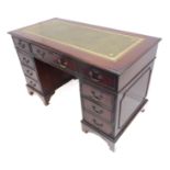 A reproduction mahogany pedestal desk; the green gilt tooled leather inset top above an