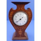 An early 20th century Art Nouveau inspired mantle clock; shaped mahogany case with boxwood marquetry