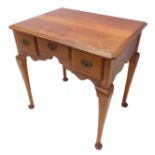 A small 18th century style (modern) cherrywood lowboy; the moulded top with re-entrant front corners