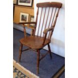 A late 19th century latheback style open arm kitchen chair with shaped elm seat and turned