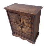 An antique style colonial miniature side cabinet of small proportions; the outset cleated top