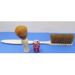An oversized toothbrush and shaving brush, originally display items of Simpsons (the shaving brush