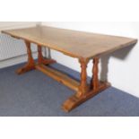 An old kitchen-style pine table; the cleated, planked well-patinated top above two sets of double